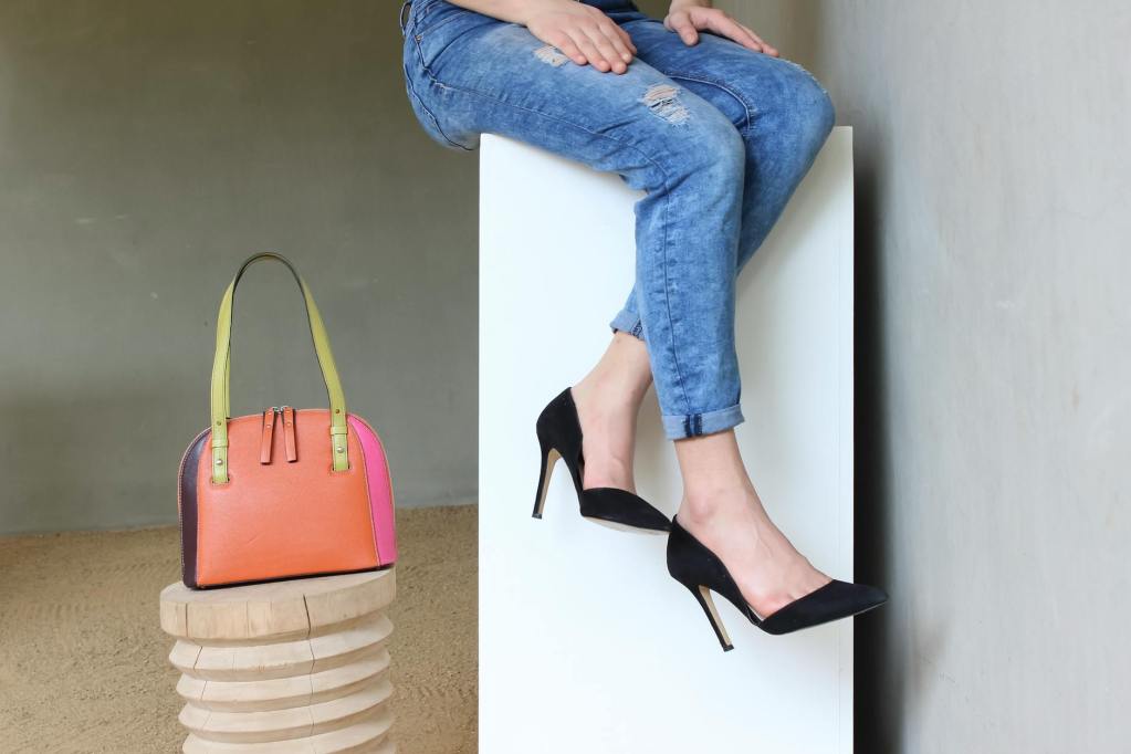 elegant fashion display with denim jeans and handbag